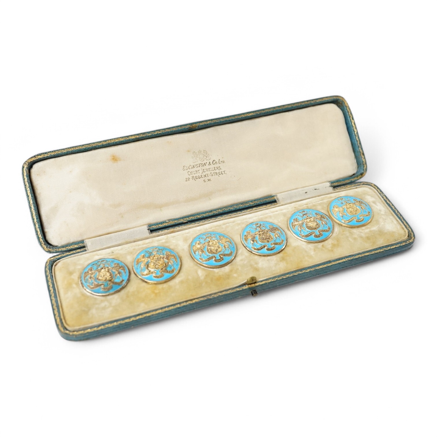 A George V set of 6 blue enamelled silver gilt buttons with armorial and motto 'cumnia subjescisti subpedieue oves et loves', Elkington and Co, Crown Jewellers, Chester 1904, in original case inscribed 'With The Complime